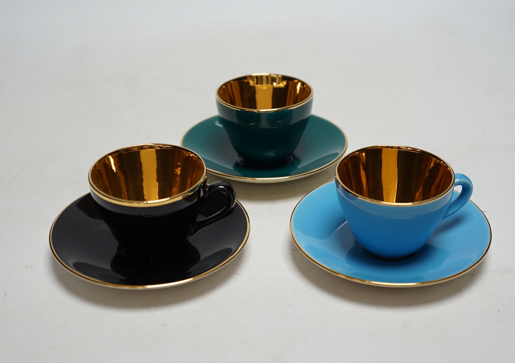 Fourteen Copenhagen Alumina, ‘Confetti’ patterned coffee cups and saucers in varying colours with gilt interiors